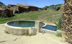 there is a small pool in the middle of an old building that has been built into it