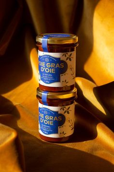 three jars of preserves sitting on top of a table