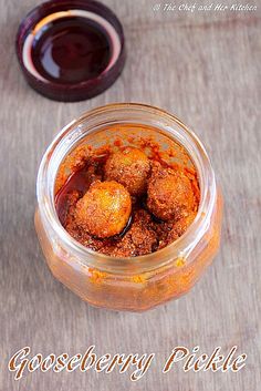 a jar filled with food sitting on top of a wooden table