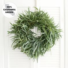 a green wreath hanging on the front door