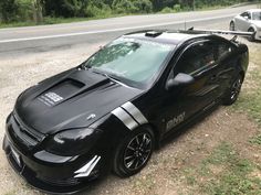 a black sports car parked on the side of the road