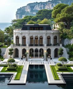 a large white house sitting on top of a lush green hillside