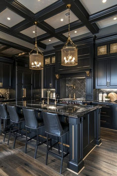 a large kitchen with black cabinets and an island