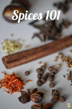 an assortment of spices on a white surface