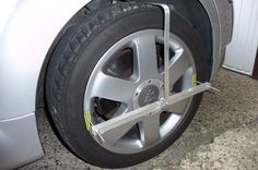 there is a car tire that has been placed on the ground with a wheel lifter attached to it