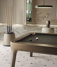 a pool table in the middle of a room with some candles on top of it