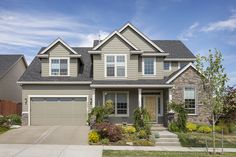 a large house with two garages in the front yard