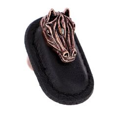 a close up of a horse head on a black slipper