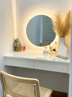 a white desk with a mirror and chair