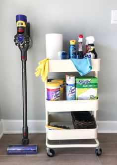 a white cart with cleaning supplies on it