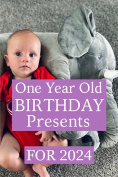 a baby sitting next to an elephant with the words one year old birthday presents for 2014