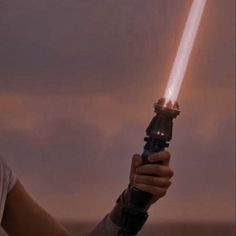 a woman holding a light saber in her hand