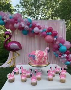 a flamingo themed birthday party with cupcakes and balloons