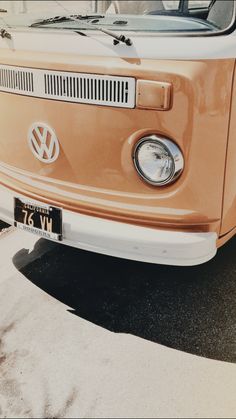 an old vw bus parked in a parking lot