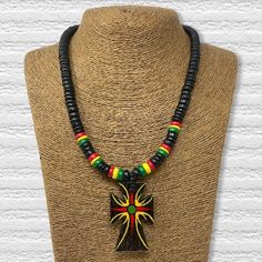 Handmadeafrican necklaces Gorgeous, vibrant, beautifully crafted unisex African inspired necklace made from wood. Fits around the neck conveniently with a measurement of 20 inches in length. It is a masterfully designed handmade necklace with the customer in mind.This Africa Shaped Pendant Beaded Necklace is a great Afrocentric Men's necklace. The large black designed pendant is 3 inches long. The necklace is approximately 20 inches long. The beaded necklace has black with accents of green, yell Black Wooden Beaded Necklace For Festivals, African Beaded Necklace, Spiritual Brown Hand-strung Beaded Necklaces, Jamaican Beaded Necklace, Rasta Necklace, African Pendant Necklace, Ankh Necklace, Basket Weaving Patterns, Friendship Bracelets With Beads