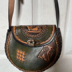 Mexican Handmade Leather 100 Percent Made In Cancun Mexico Color Hunter Green W Brown Aztec Greek Style Very Durable One Of A Kind W Adjustable Strap Very Unique Brand New . Handmade Beautiful Handbag. See Photos For Description Handmade Leather Hobo Bag In Pouch Shape, Hand Tooled Crossbody Bag For Daily Use, Hand Tooled Crossbody Travel Bag, Handmade Leather Pouch Shoulder Bag, Artisan Hand-tooled Shoulder Bag, Green Hand-tooled Bag For Daily Use, Green Hand Tooled Bag For Daily Use, Traditional Leather Crossbody Shoulder Bag, Bohemian Leather Shoulder Bag With Detachable Strap