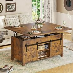 a living room with a coffee table and couches in it's center area