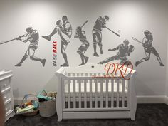 a baby's room with a crib and wall decals depicting baseball players