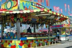 an amusement park with colorful rides and flags