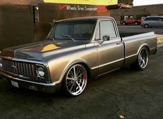 a silver truck parked in front of a building