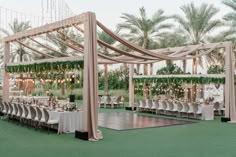 an outdoor wedding setup with tables and chairs