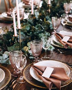 the table is set with place settings and candles