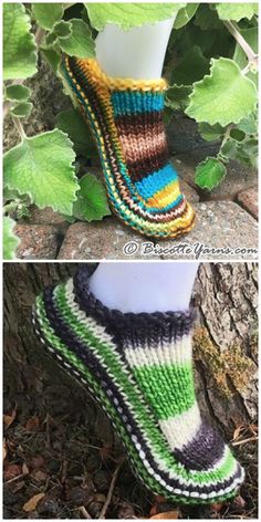 a pair of slippers that are knitted in different colors and sizes, sitting on top of a tree stump