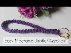 a purple lanyard with a gold ring on it and flowers in the background text reads easy macrame twistet keychain