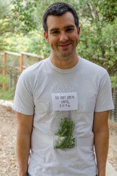 a man wearing a t - shirt that says do not open 2013