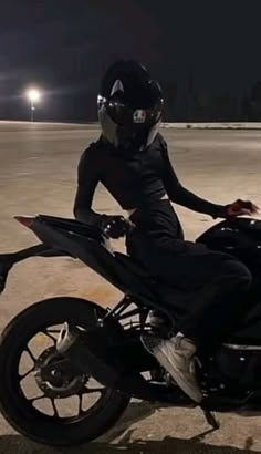 a person on a motorcycle in the dark