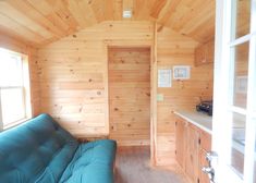 a couch in a room with wooden walls