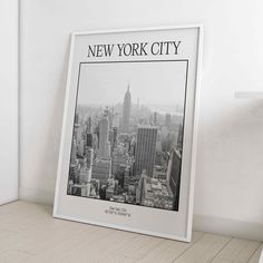 the new york city skyline is shown in this black and white photo, framed on a wall