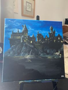 a painting of hogwarts castle is shown on an easel