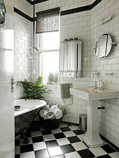 a bathroom with black and white checkered flooring, a claw foot bathtub