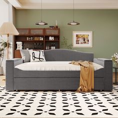 a living room with green walls and black and white flooring