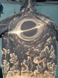 a black and brown hoodie with swirls on it