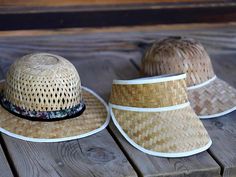 three hats sitting on top of a wooden table