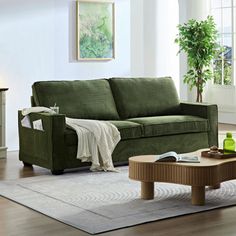 a living room filled with furniture and a coffee table on top of a wooden floor