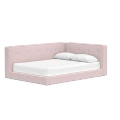 a pink bed with white sheets and pillows