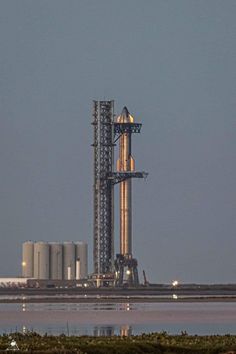 an airplane is flying over a large tower