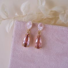 Introducing the Kelsea Pink Drop Earrings, where whimsy meets elegance! These earrings feature genuine Rose Quartz stones, radiating love and positive vibes. Set in a yellow gold plated setting, they offer durability and style! The pink glass teardrop charm adds a flirty and fun element to any ensemble. Embrace your inner charm and let these Kelsea Pink Drop Earrings be your go-to accessory! EARRINGS FEATURE Genuine Rose Quartz set in a yellow gold plated setting(.925 sterling post) with a pink Gold And Pink Jewelry Aesthetic, Pink Gem Earrings, Pink Earrings Aesthetic, Nora Universe, Radiating Love, Pink Stone Earrings, Spring Court, Pink Drop Earrings, Outfit Aesthetics