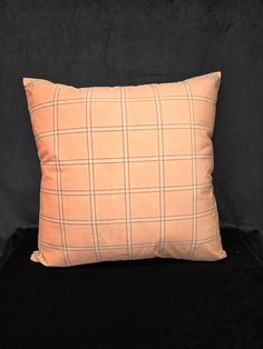 an orange pillow on a black background