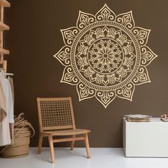 a room with a chair and a wall sticker on the wall that has an intricate design