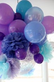 a vase filled with purple and blue balloons