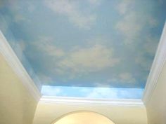 the sky is painted on the ceiling in this room with blue and white clouds above