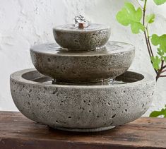 three stone bowls are stacked on top of each other with water running down the sides