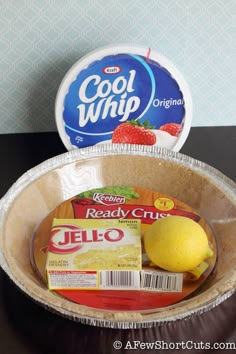 a paper plate with some food in it on a table next to a container of yogurt