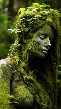 a statue made out of moss in the woods