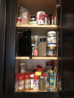 an organized pantry with spices, seasonings and condiments in the cabinet door