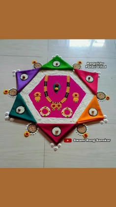 colorful rangdi work on the floor for diwaling with beads and pearlss